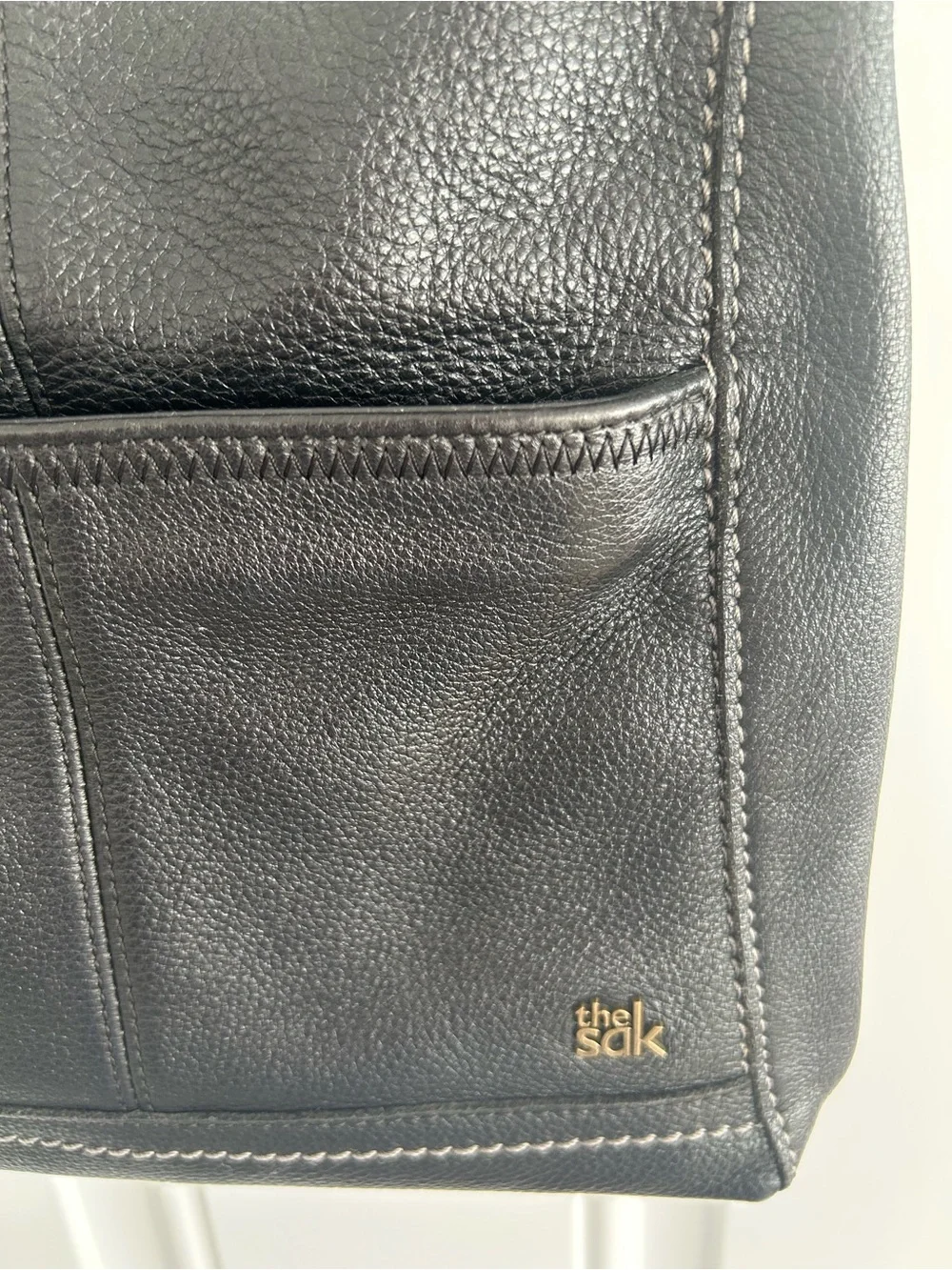 The Sac Iris Black Pebbled Leather Crossbody Bag Adjustable Strap Brass Hardware